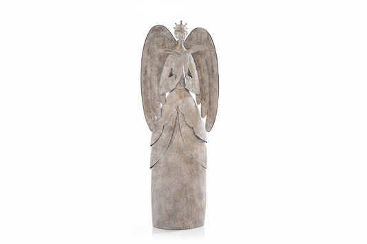 A large decorative angel statue with outstretched wings and a long draped gown, shown standing on a tabletop against a dark brown background. The statue has a weathered stone-like finish in light gray and beige tones.